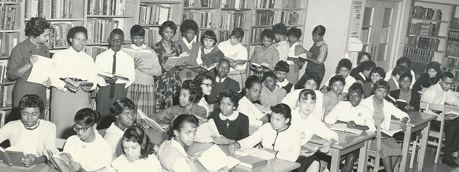 Black and white photograph of students in the school library.