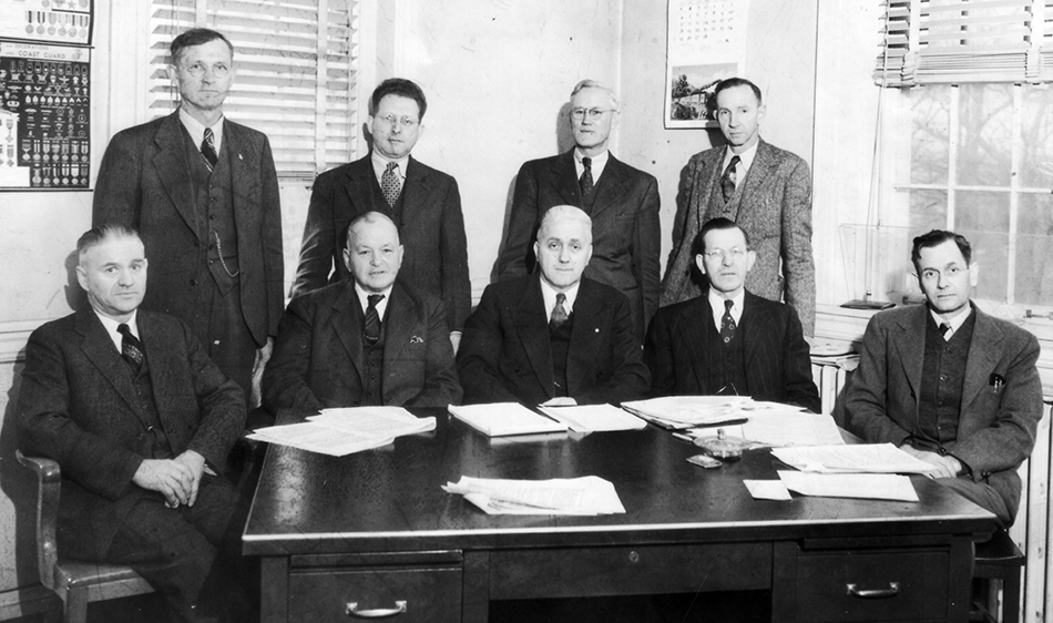 Black and white photograph of Superintendent Woodson and the School Board in 1945.