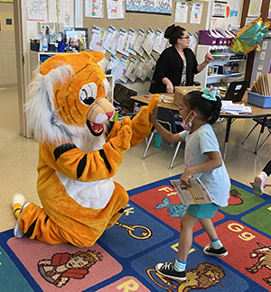 photo of Jackson the Tiger high-fiving a Westlawn student